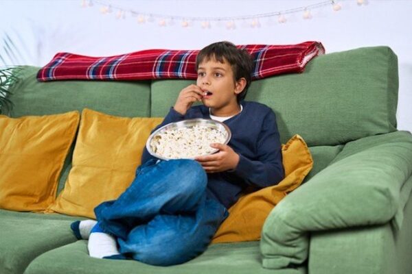 child eating and watching tv